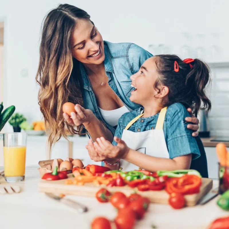 mother and daughter cooking in the kitchen