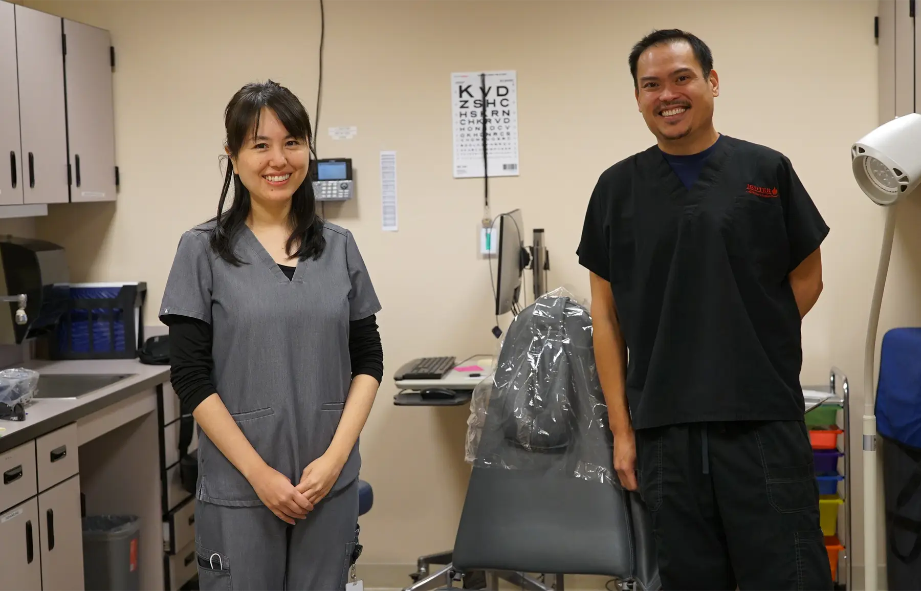 One female and one male CHC doctor in a patient room