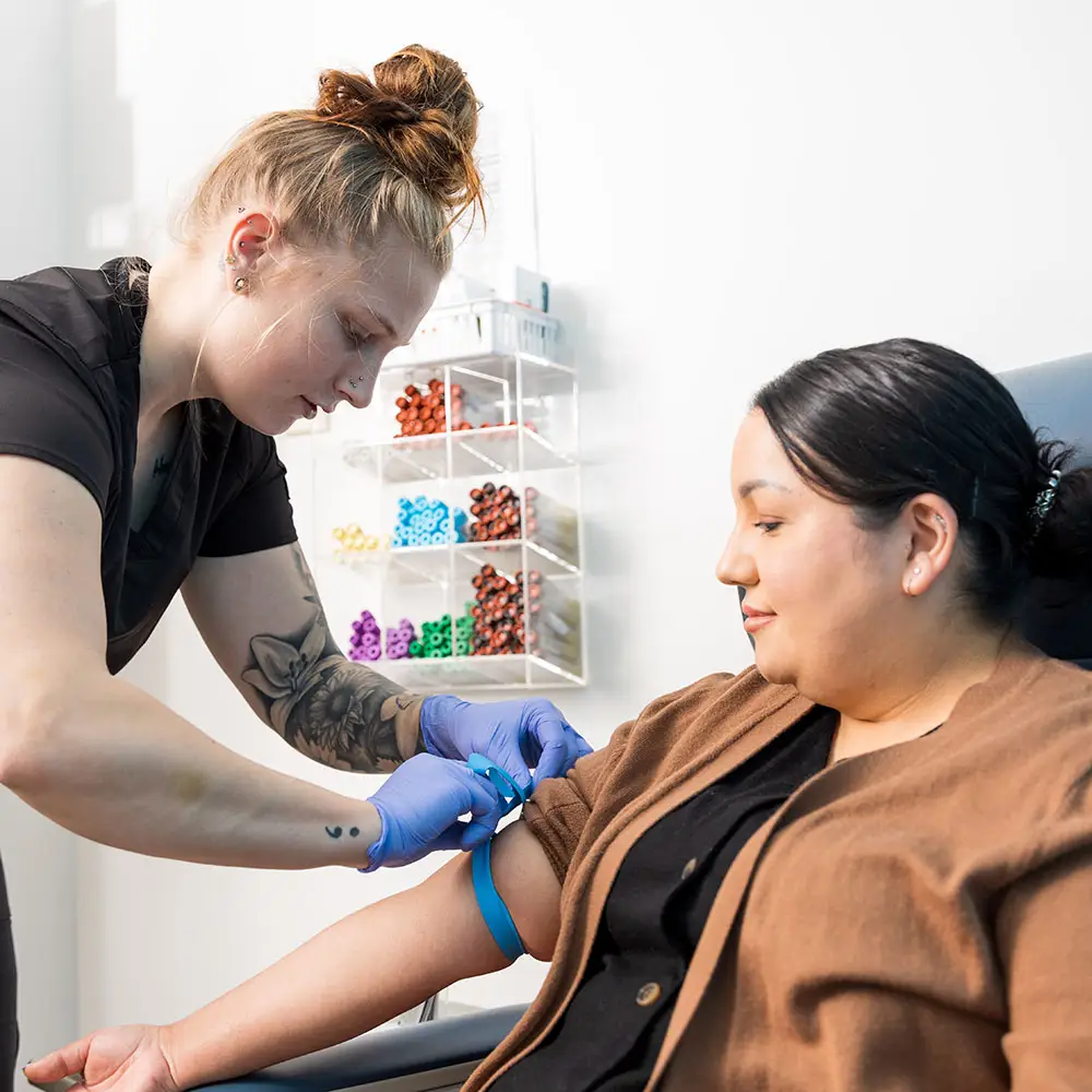 Nurse drawing blood from patient